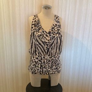 Sleeveless, ruffle front, pleated bottom, elastic back bottom.